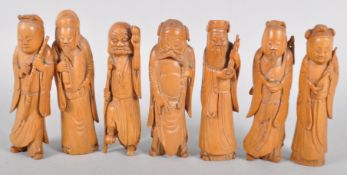 A quantity of Chinese carved wood sculptures of Immortals holding musical instruments