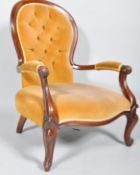 A reproduction Victorian mahogany spoon back armchair having carved arms and legs with button back