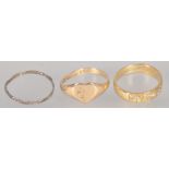 A collection of three rings to include: A 9ct gold heart shaped signet ring;