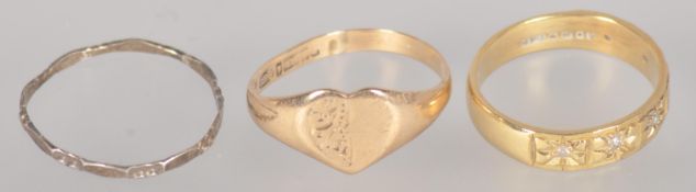 A collection of three rings to include: A 9ct gold heart shaped signet ring;