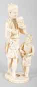 An early 20th century ivory Japanese Okimono of a father and child, the father holding a Noh mask,