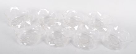 A set of eight 19th century wrythen moulded glass finger bowls having a pinched and fluted form