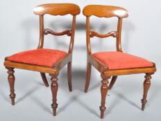 A pair of George IV mahogany dining chairs, with carved yoke form top rails,