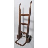 An early 20th century industrial oak and steel sack truck with notation to sides