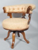 A Victorian upholstered revolving desk chair, with button upholstered back, scrolled supports,