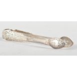 An Irish silver pair of sugar tongs, in the fiddle pattern, with heavy floral and scroll engraving,