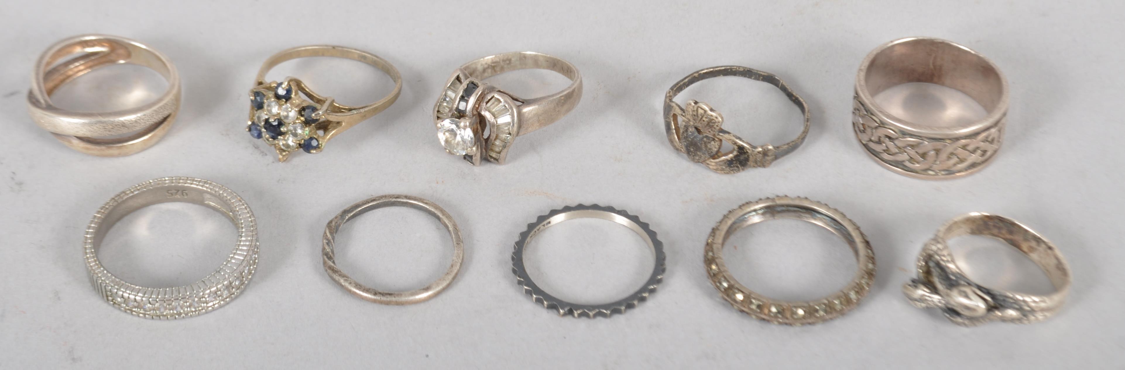 Ten assorted white metal rings, some stamped .