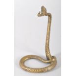 A Victorian-style brass stand modelled as a serpent partially coiled,