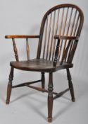 A stained elm Windsor kitchen chair, with spindle back,
