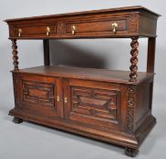 A Jacobean style oak two tier buffet, the top section set with two drawers,