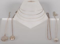 A collection of jewellery to include: Three oval shaped silver lockets with chains;