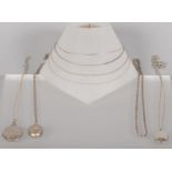 A collection of jewellery to include: Three oval shaped silver lockets with chains;