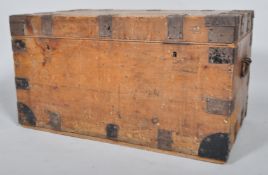 A pine and studded metal mounted travelling trunk, with carrying handles,