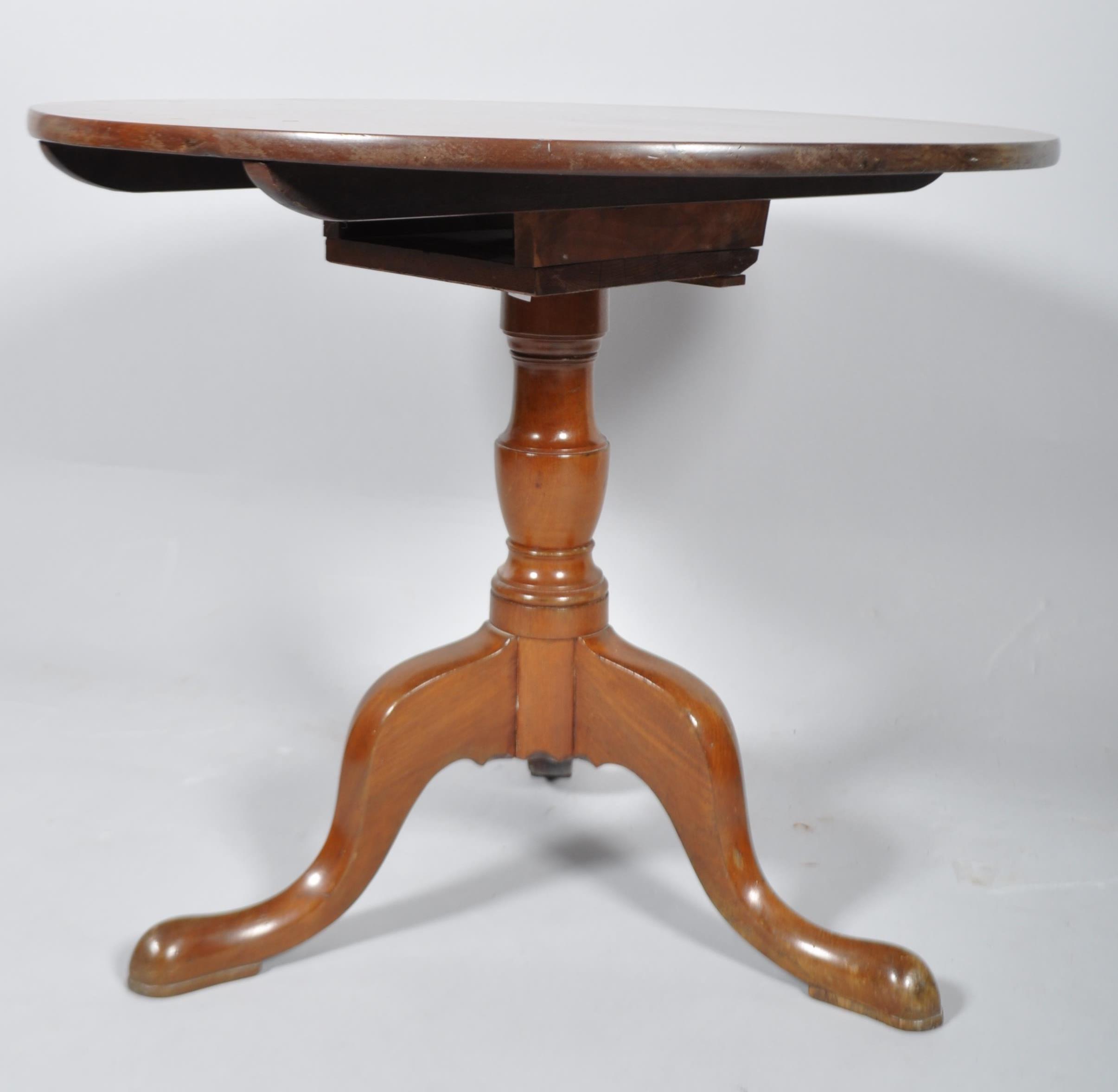 A mahogany tripod tilt-top tea table, with circular top above a baluster stem and tripod legs, - Image 2 of 3