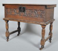 An oak carved bible box on stand, carved with a frieze of bell shaped flowers and tendrils,