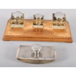 A mahogany ink stand, the three square glass ink wells with silver lids, Birmingham 1919/20,