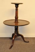 A mahogany two-tier dumb waiter,in the George III style, on turned baluster stem,