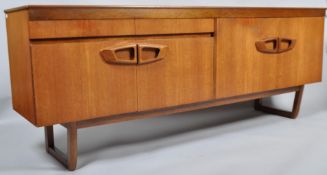 A 1960's Danish inspired retro vintage teak wood sideboard having a twin drawer over twin door