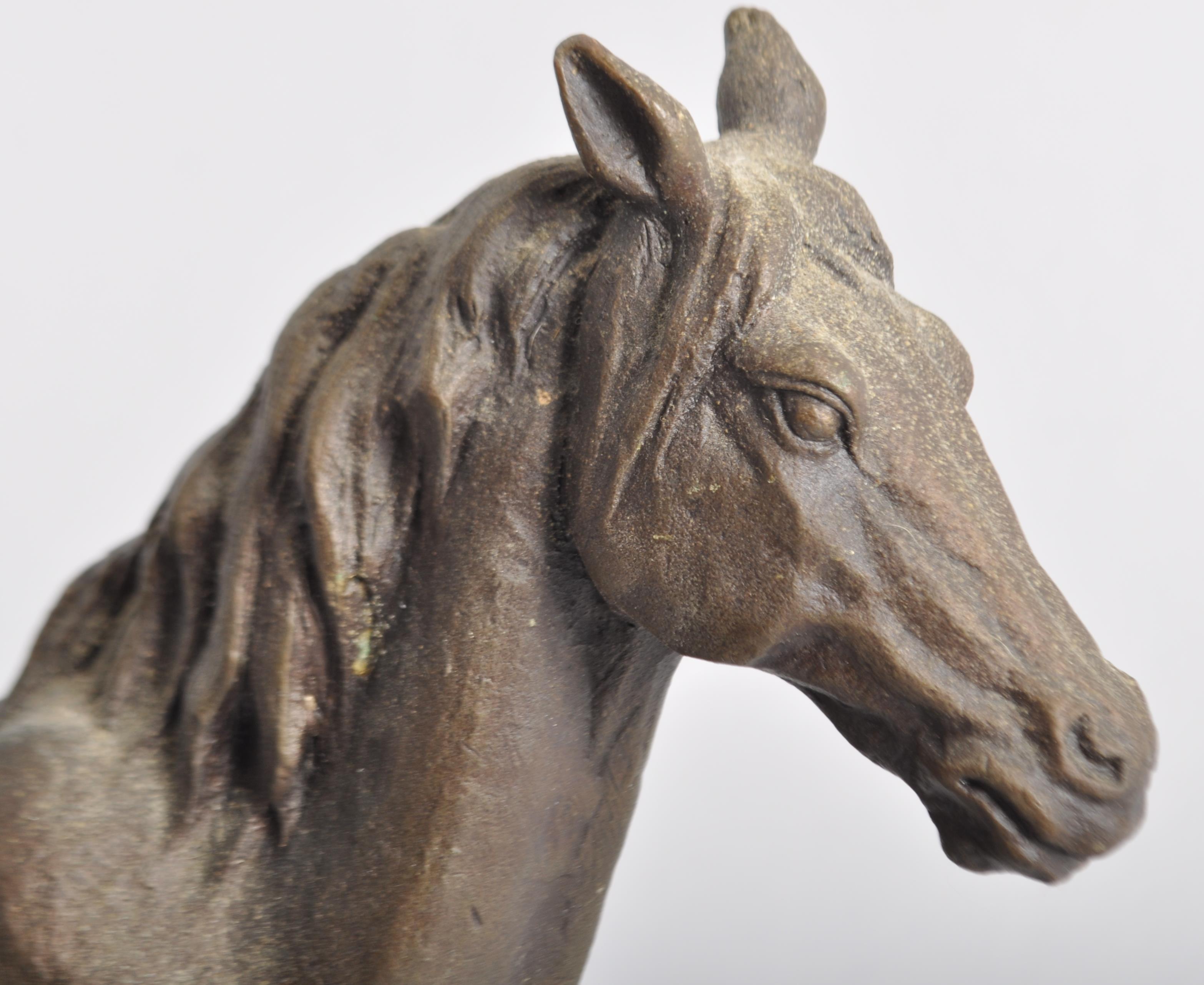 A bronze sculpture of a horse, naturalistically cast standing foresque on a rocky rectangular base, - Image 2 of 2