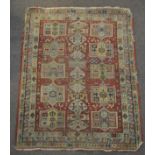 A MIddle Eastern rug with central claret ground,