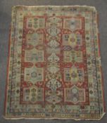 A MIddle Eastern rug with central claret ground,