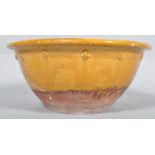 A 19th century terracotta diary bowl, with decorated prunts beneath a flared rim,