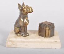 An Art Deco bronze and marble ink stand with a square canted inkwell with hinged cover