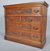 An oak drop front secretaire, carved with palmettes and acanthus scrolls,