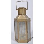 A hanging brass electric lantern, early 20th century, of canted D-section, with glazed doors,