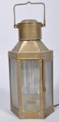 A hanging brass electric lantern, early 20th century, of canted D-section, with glazed doors,