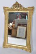 A carved giltwood and gesso georgian-style late 19th century overmantle mirror,