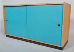 A late 20th century sideboard storage cupboard having turquoise painted sliding doors to front,