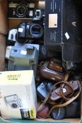 A quantity of film and digital cameras,