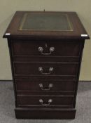 A mahogany filing cabinet with leather inset top