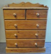 A pine chest of two over three drawers on plinth base