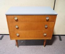 A teak chest of drawers