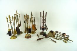 A group of brassware including fire companions