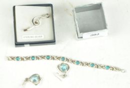 A white metal topaz bracelet earring and a brooch