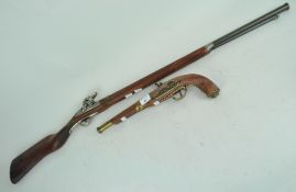 A replica flintlock rifle and pistol