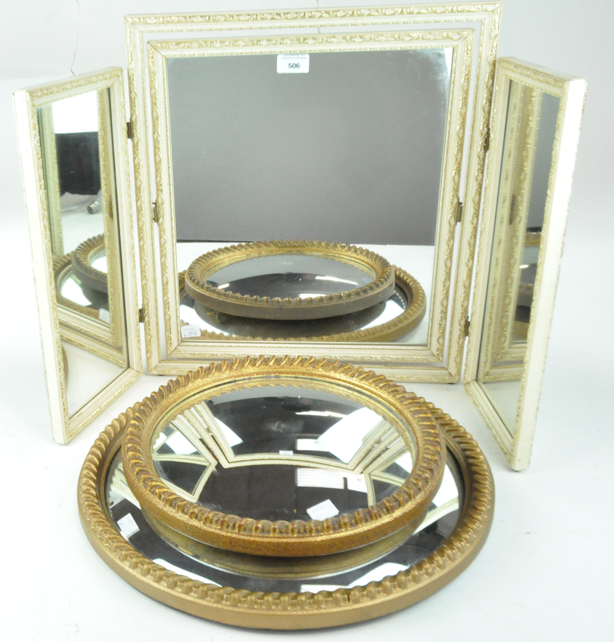 Two gilt framed convex mirrors and a triple framed