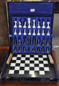 A marble chess set and board in a case