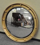 A round gilt mirror