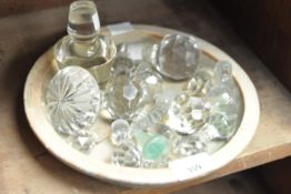 A dish of vintage crystal decanter stoppers