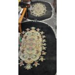 A pair of black oval rugs