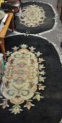 A pair of black oval rugs