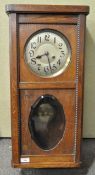 An oak cased wall clock