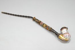 A 19th century Continental porcelain pipe, with floral decoration and brass mounts,