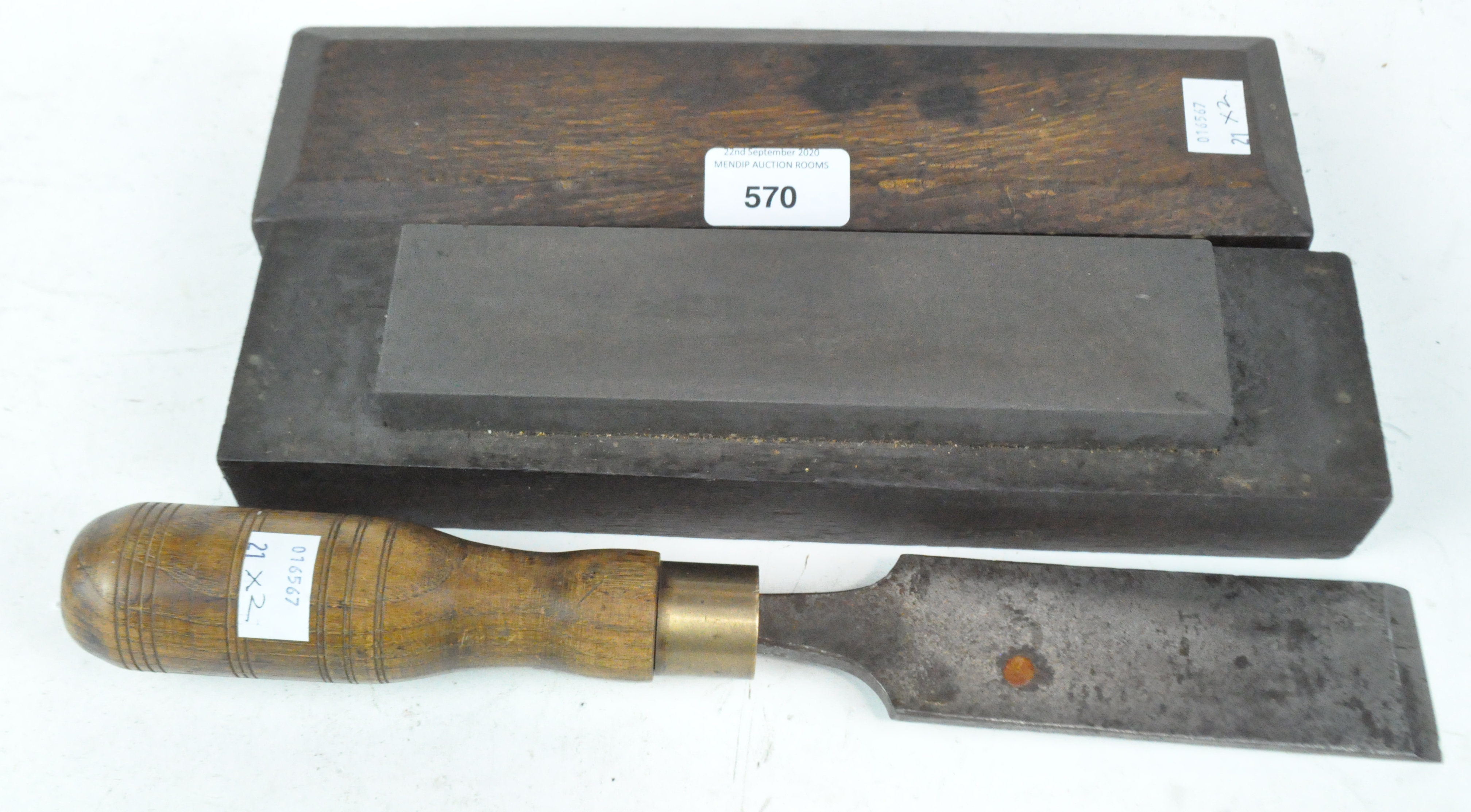 A large chisel and an oak cased sharpener