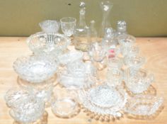 A collection of clear pressed and cut glass, to include a decanter,