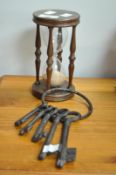 A large vintage hourglass egg/sand timber clock and cast iron keys